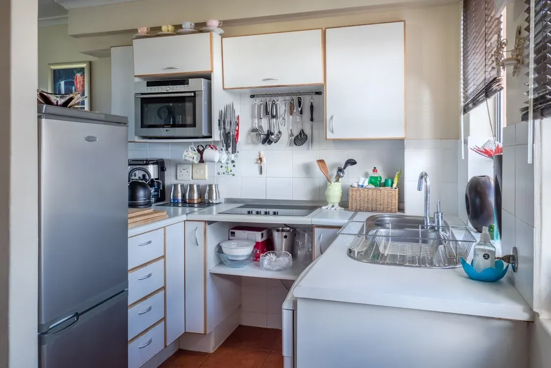 White bathroom cabinetry with dual vessel sinks and modern mirror