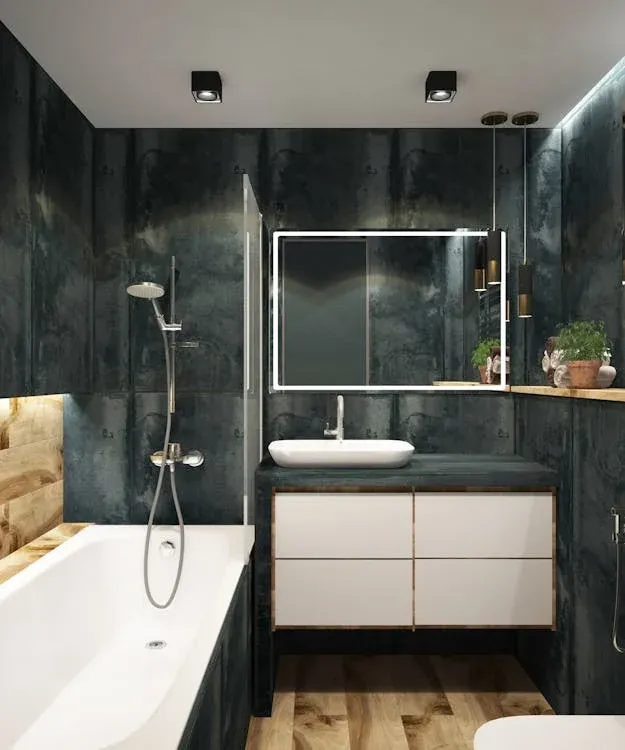 Modern black and white bathroom with oval mirror, vanity, and chrome fixtures